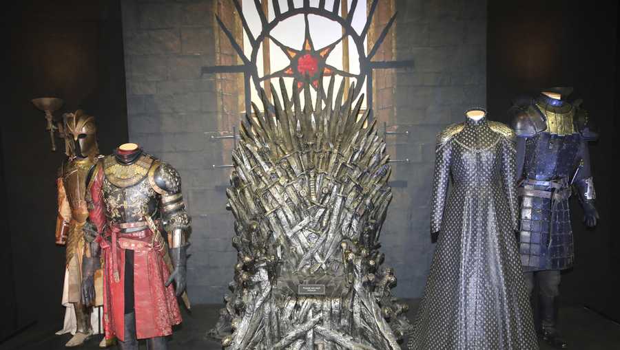 FILE - The Iron Throne and costumes on display during the launch of The Game of Thrones Touring Exhibition at the Titanic Exhibition centre in Belfast, Northern Ireland, Wednesday, April 10, 2019.  (AP Photo, File)