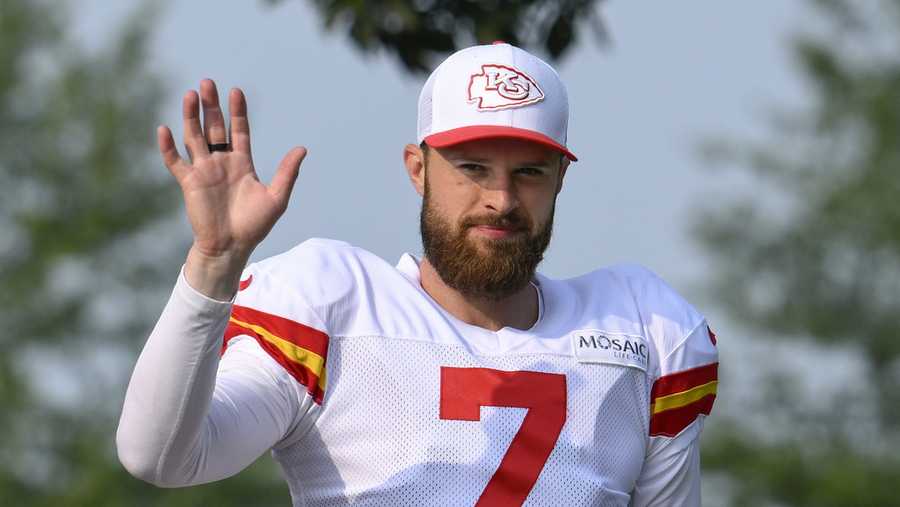 Kansas City Chiefs kicker Harrison Butker waves to the fans as he walks to the field at the start of an NFL football training camp Saturday, July 27, 2024, in St. Joseph, Mo. (AP Photo/Reed Hoffmann)